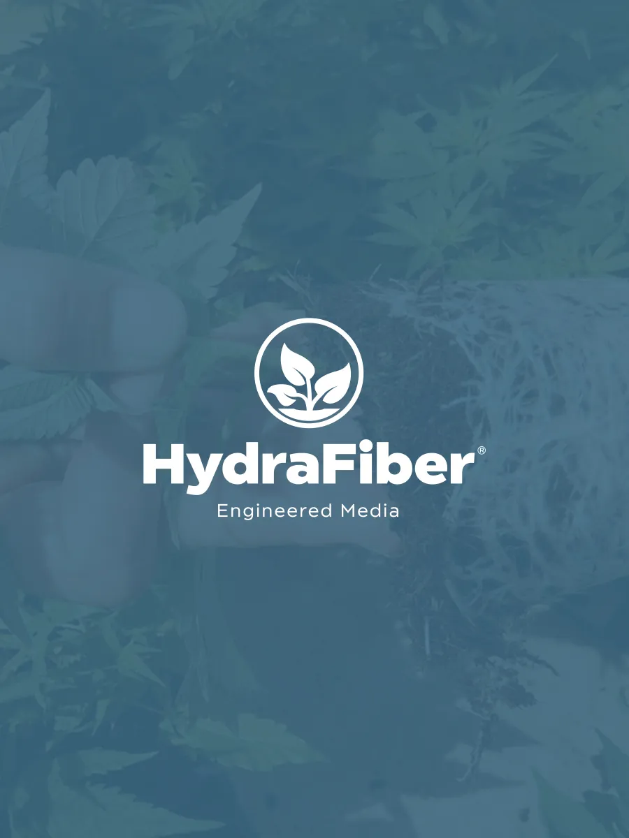 A hand holding a plant with visible roots in soil, overlaid with the HydraFiber logo and the words Engineered Media..