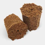 Two pieces of dark brown, crumbly compressed soil or organic matter, shown on a white background.