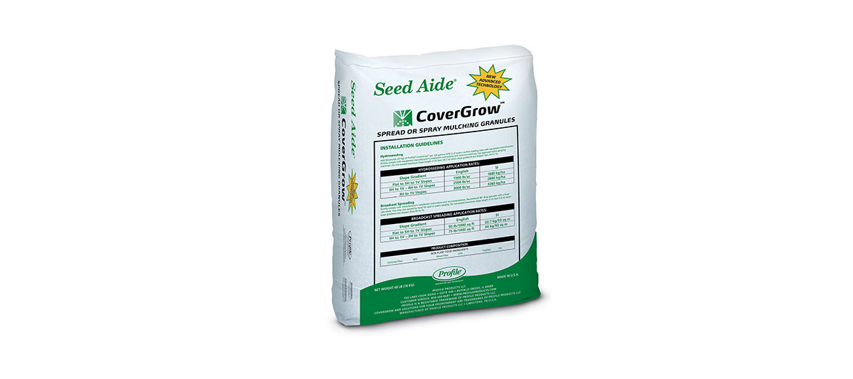 A white and green bag of Seed Aide CoverGrow, a product for grass seed and soil protection, shown standing upright with the product label, usage instructions, and tables visible on the front.