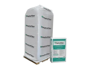A large white pallet wrapped in plastic and labeled HydraFiber stands next to a smaller HydraFiber EZ Blend product box with green and white labeling, against a plain white background.