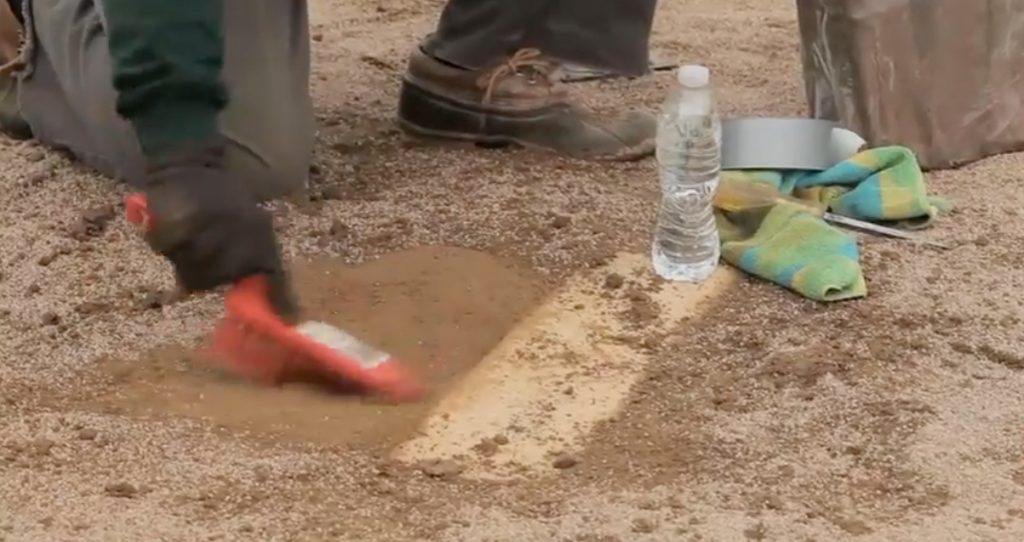 Repairing pitchers mound.