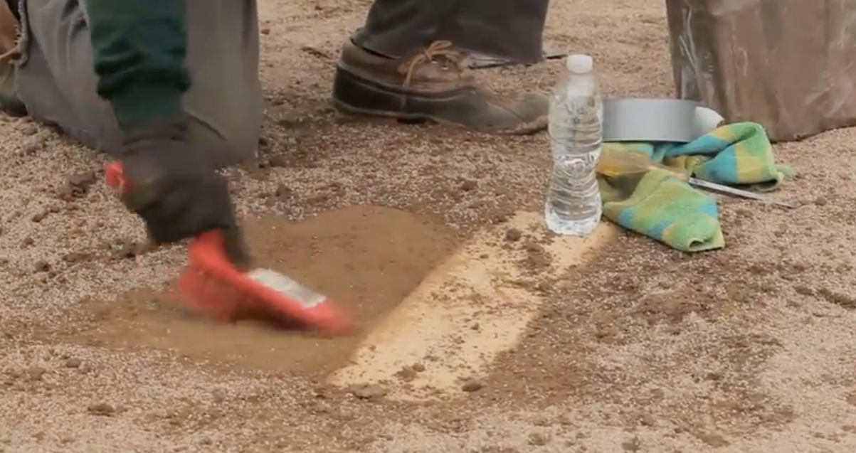 Repairing pitchers mound.