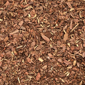 Close-up texture of brown wood mulch spread across the ground.