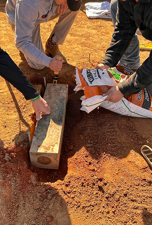 Grounds crew installing a pitchers mound.