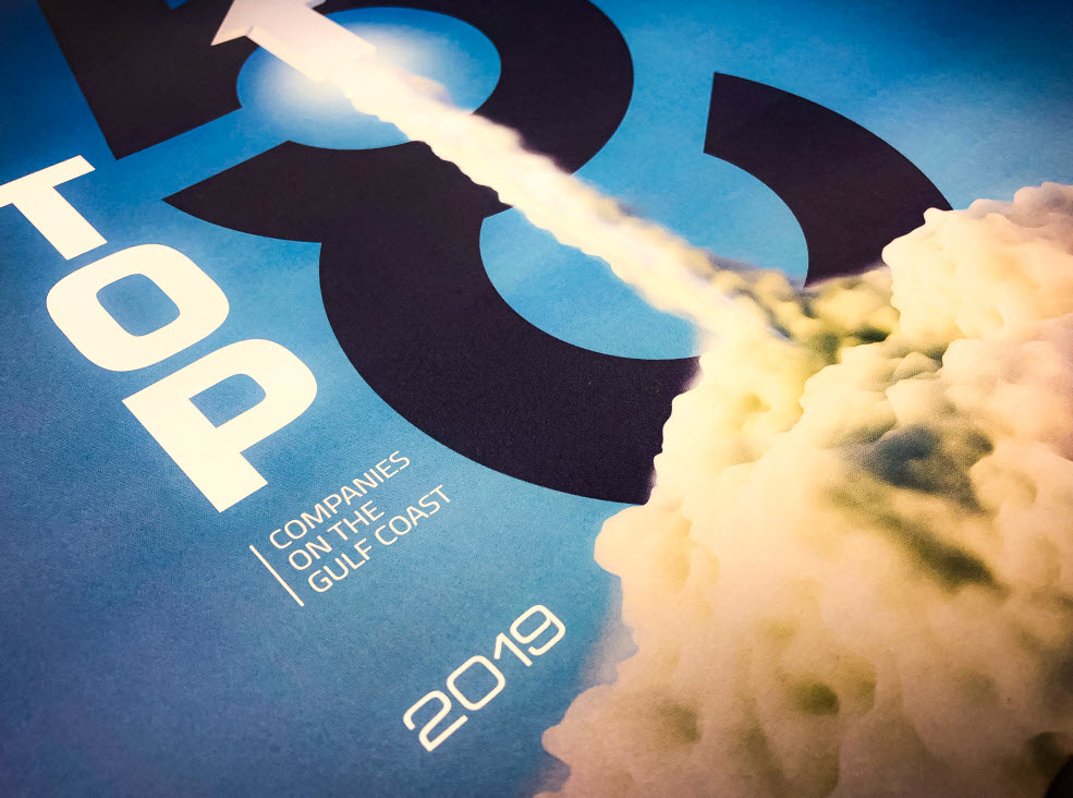 Magazine cover with Top Companies on the Gulf Coast 2019 in bold white text, featuring a rocket launching upward against a blue background, leaving a white smoke trail.