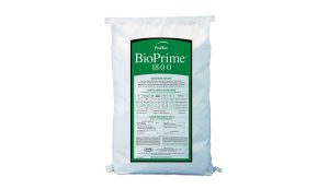 A white bag labeled BioPrime 18-0-0 with detailed usage instructions and application rates printed on a green and white front label. The bag appears to contain fertilizer or a similar product.