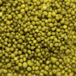 Close-up of a large pile of yellow peas, filling the entire frame. The peas vary slightly in size and shape, creating a textured and densely packed appearance.