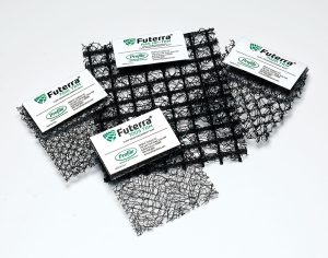 Four black mesh samples, each with varying grid patterns and densities, are arranged on a white surface. Each sample has a label marked Futerra and Profile, indicating different product types.