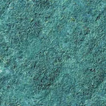 Close-up texture of green hydroseed mulch with visible shredded fibers and small organic fragments forming a dense ground cover.