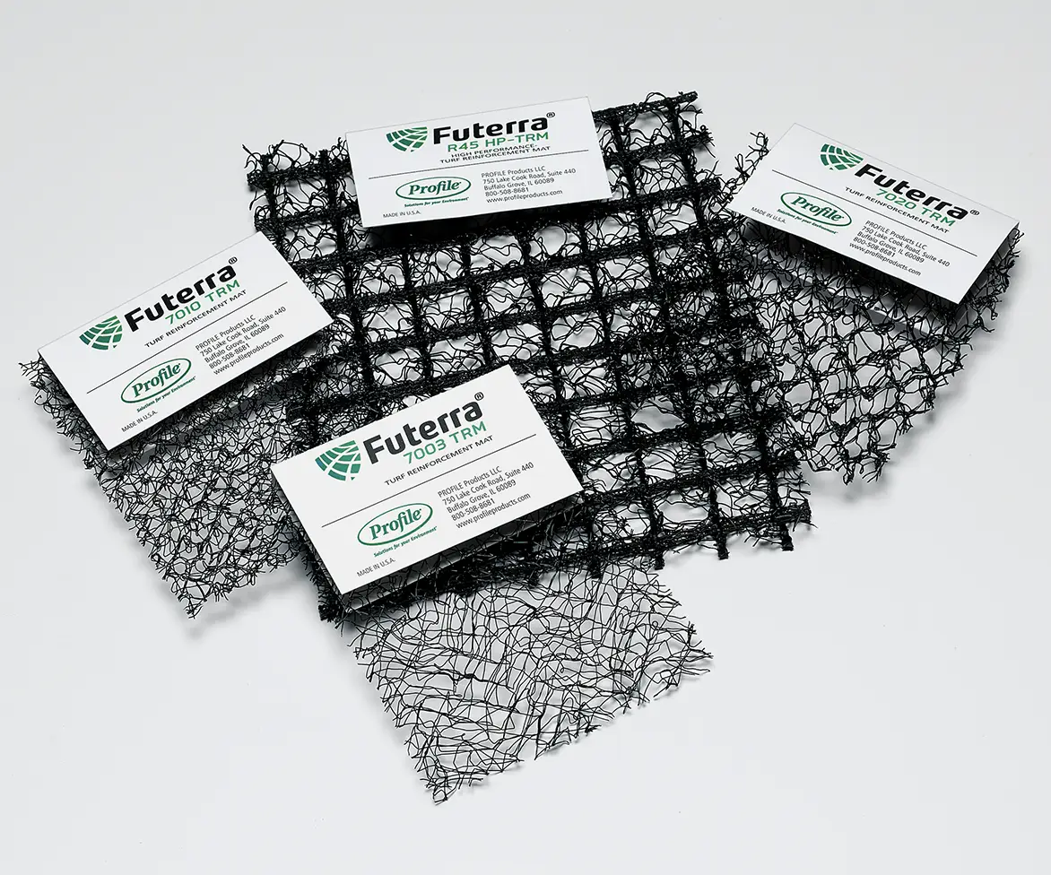 Samples of black turf reinforcement mesh with product cards labeled “Futerra 7003 TRM,” “Futerra R45 TRM,” “Futerra 10200 TRM,” and “Futerra 1010 TRM.”