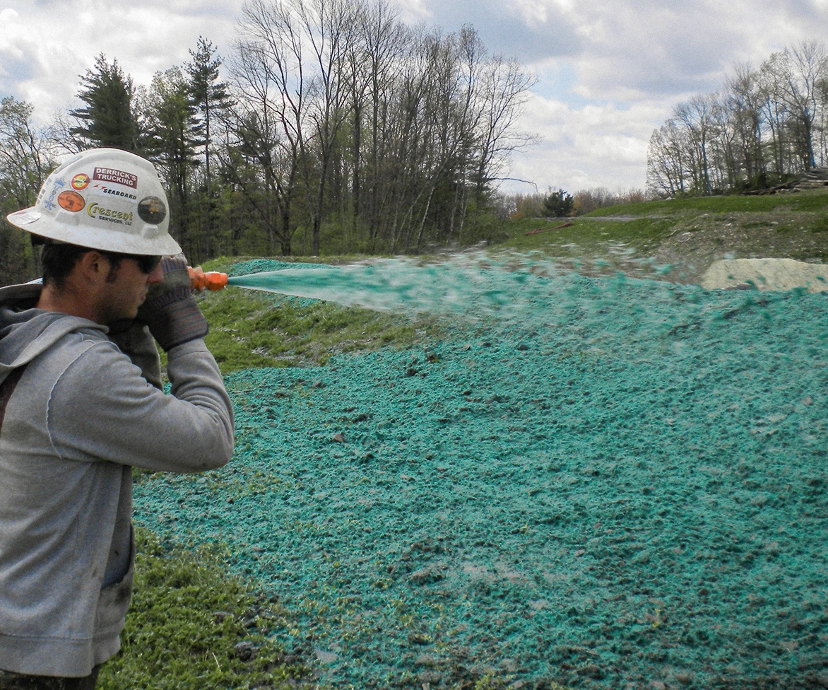 Groundcrew applying profile products to landscaping.