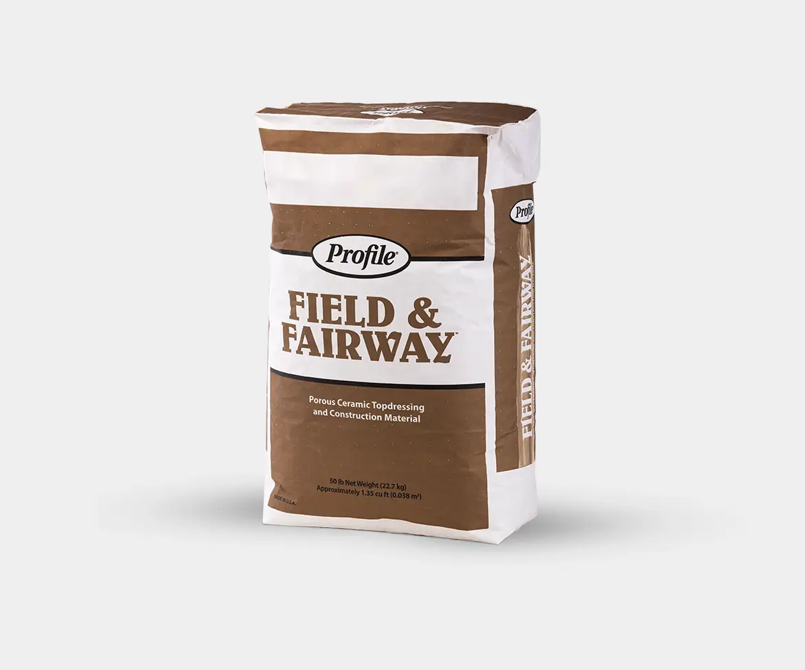 Two bags of Profile porous ceramic topdressing material labeled “Field & Fairway” (brown bag) and “Emerald Field & Fairway” (green bag) displayed side by side on a white background.