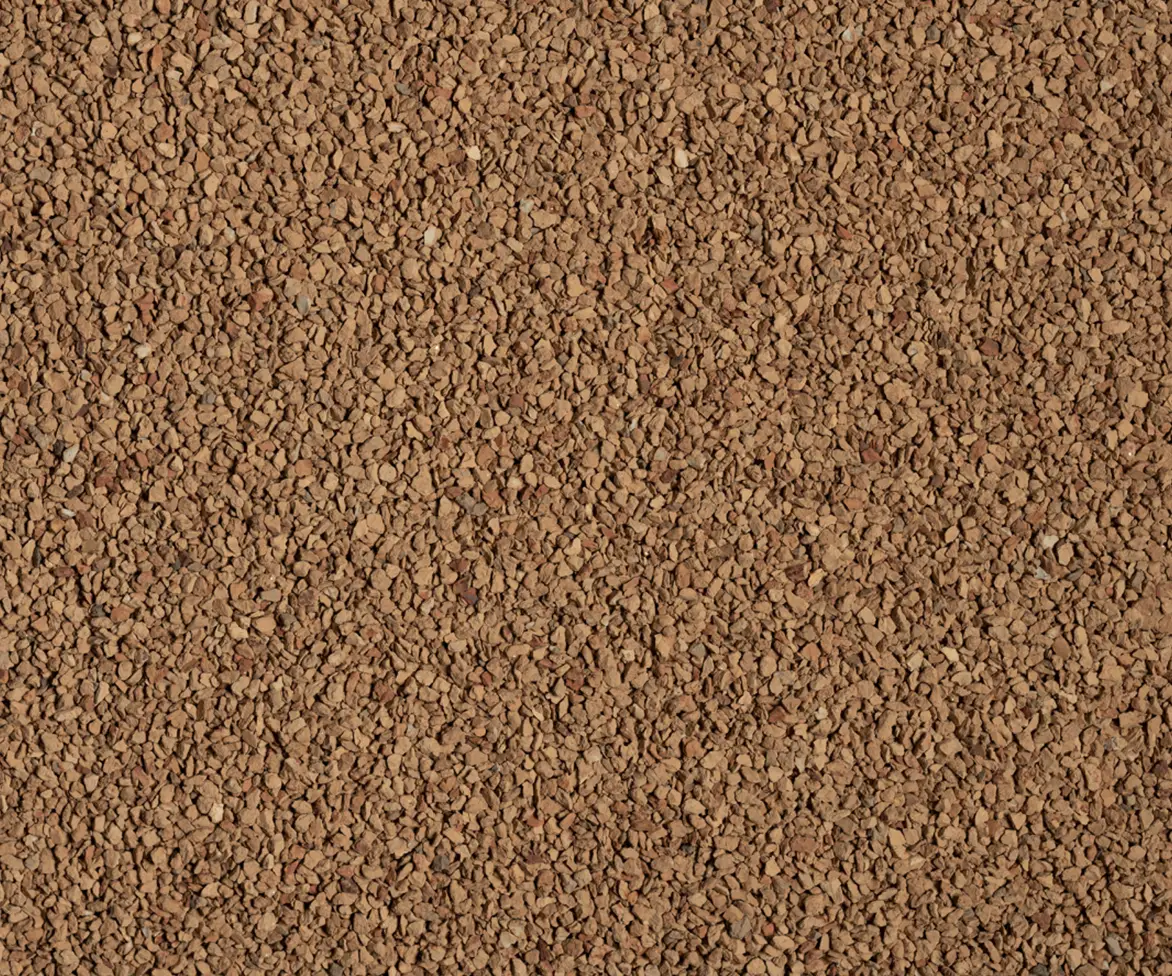 Close-up texture of light brown granular infield material.