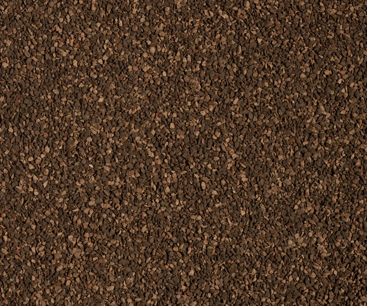 Close-up texture of dark brown granular infield material.