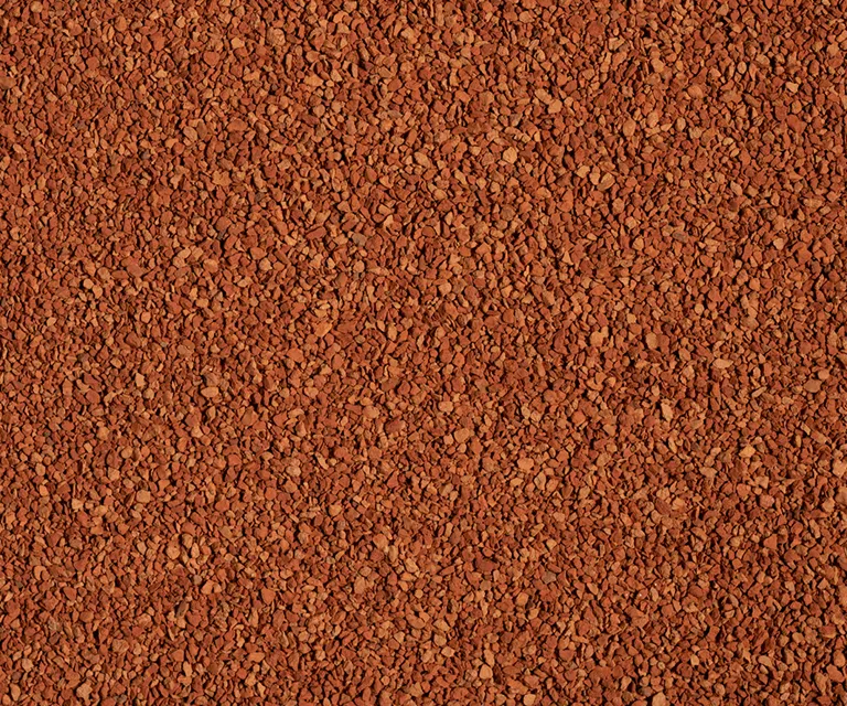 A close-up view of a Turface Elite Red granules. 