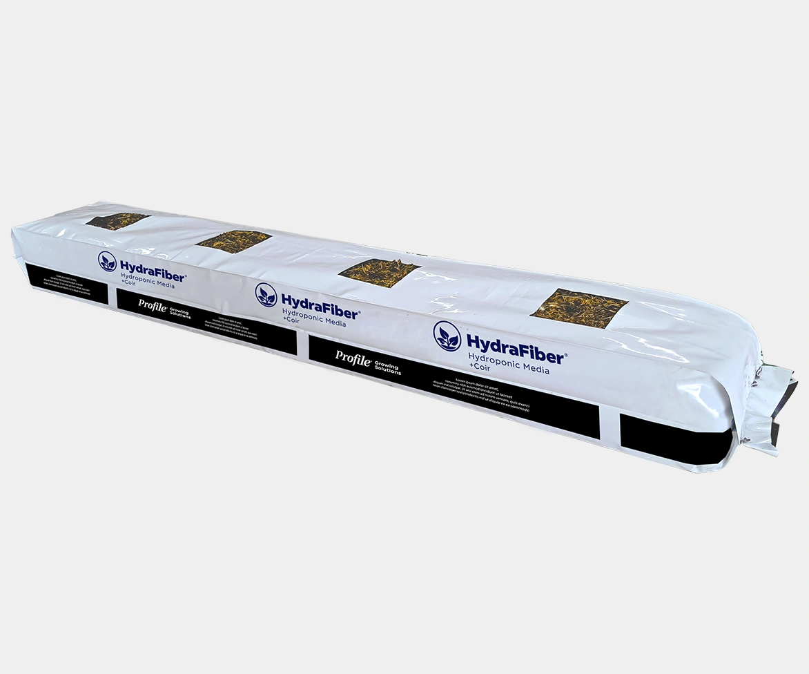 A long, rectangular white bag labeled HydraFiber Hydroponic Media with visible brown growing medium inside and black and blue branding on the packaging.