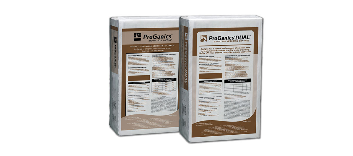 Two white bags labeled ProGanics and ProGanics DUAL, featuring brown and beige text panels with product details and charts, standing upright on a white background.