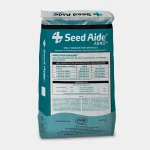 A bag of Seed Aide Aero soil stabilization granules stands upright. The bag is mostly teal with white and blue text, showing application guidelines, product information, and branding on the front.