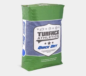 A green and blue 50-pound bag labeled Turface Athletics Quick Dry, used for field conditioning and moisture management in sports fields. The bag features various sports icons and product information.
