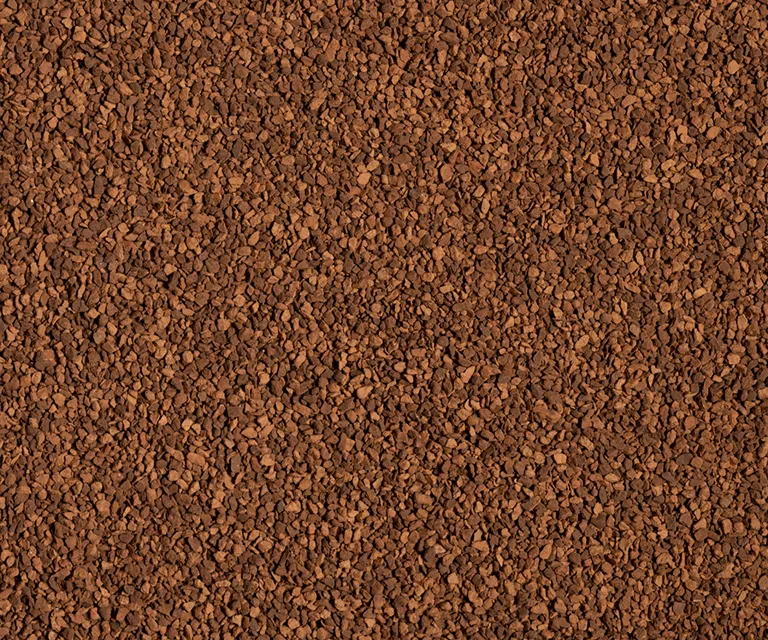 A close-up view of a Turface Elite Heritage Red granules.