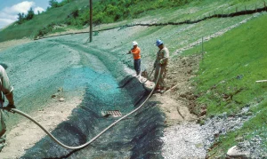 Workers spraying Flexterra along the Northeast BC Pipeline
